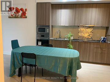 Toronto (Bay Street Corridor) condo for rent - A dining table with a green tablecloth and a chair in front of it.