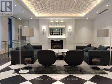 Toronto (Bay Street Corridor) condo for rent - A living room with a fireplace and a checkered floor.