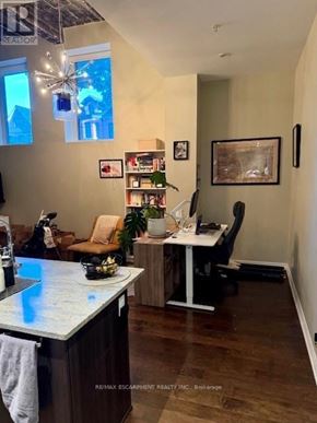 Hamilton (Central) condo for rent - A room with a desk, chair, and a potted plant.