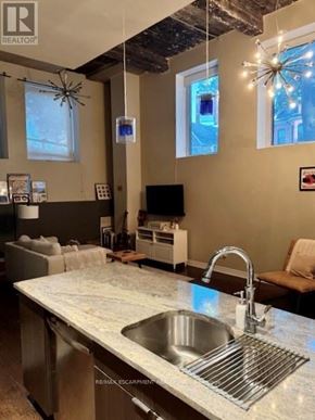 Hamilton (Central) condo for rent - A kitchen with a marble countertop and a sink.