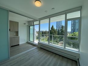 Surrey apartment for rent - A room with a large window overlooking a cityscape.