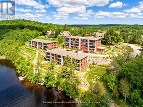 Huntsville (Chaffey) condo for rent - An aerial view of a resort with buildings and a lake.