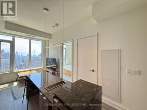 Toronto (Annex) condo for rent - A kitchen with a marble countertop and a view of the city.