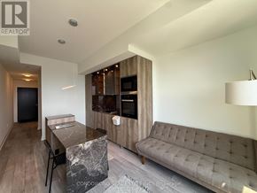 Toronto (Annex) condo for rent - A modern living room with a grey sofa and a marble table.