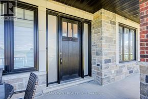 Kawartha Lakes (Manvers) apartment for rent - A house with a black door and windows is for sale.