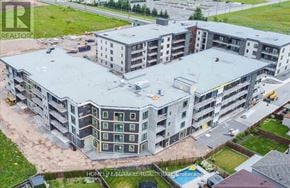 Niagara Falls (Brown) condo for rent - A large, multi-story residential building under construction with a grey roof.