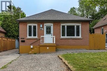 Hamilton apartment for rent - A small house with a gravel driveway in front.