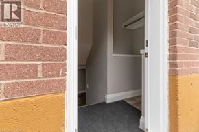 Hamilton apartment for rent - A doorway leads to a room with a brick wall on one side and a yellow wall on the other.