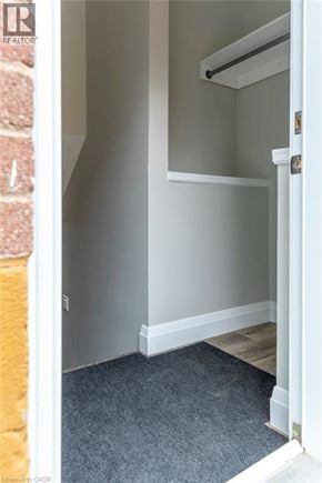 Hamilton apartment for rent - A hallway with a carpeted floor and white walls.