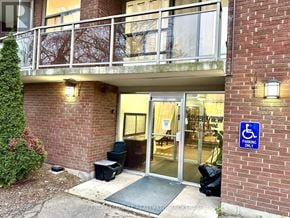St. Catharines (Glendale/Glenridge) condo for rent - A building entrance with a wheelchair sign on the wall.