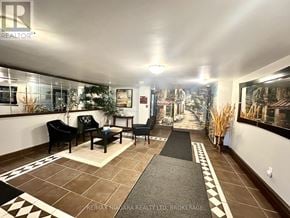St. Catharines (Glendale/Glenridge) condo for rent - A living room with a black sofa and a coffee table.