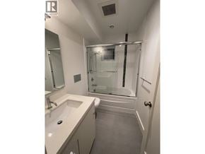 Vancouver apartment for rent - A bathroom with a sink, mirror, and shower.