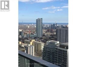 Toronto (Church-Yonge Corridor) condo for rent - A cityscape with a clear sky and buildings of various heights.
