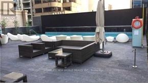 Toronto (Church-Yonge Corridor) condo for rent - A pool area with a white umbrella and a red life preserver.