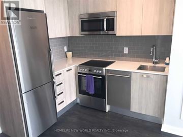Toronto (Church-Yonge Corridor) condo for rent - A modern kitchen with a stainless steel refrigerator and oven.