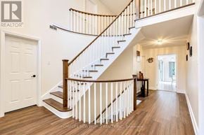 Mississauga (Erin Mills) apartment for rent - A spacious hallway with a staircase and a table with chairs.