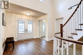 Mississauga (Erin Mills) apartment for rent - A spacious hallway with a bench and a staircase.