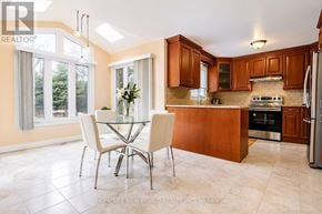 Mississauga (Erin Mills) apartment for rent - A kitchen with a table and chairs in front of a window.
