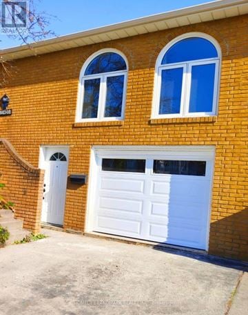 Mississauga (Cooksville) apartment for rent - A red brick house with a white garage door.