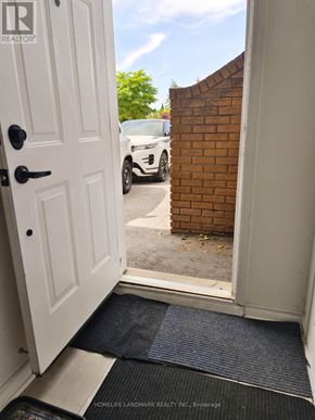 Mississauga (Cooksville) apartment for rent - A doorway with a mat on the floor leading to a driveway.