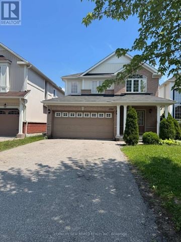 Oshawa (Pinecrest) apartment for rent - A large house with a driveway in front of it.