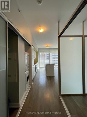 Toronto (Kensington-Chinatown) condo for rent - A hallway with a washer and dryer in it.