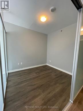 Toronto (Kensington-Chinatown) condo for rent - A room with wood flooring and a light on the ceiling.
