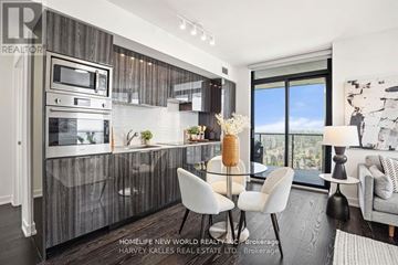 Toronto (Bay Street Corridor) condo for rent - A modern kitchen with a dining table and chairs.