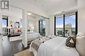 Toronto (Bay Street Corridor) condo for rent - A bedroom with a large bed and a view of the city.