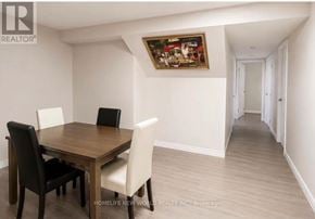Mississauga (Erin Mills) apartment for rent - A dining room with a wooden table and chairs.