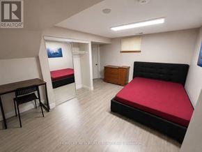 Mississauga (Erin Mills) apartment for rent - A bedroom with a red bed, a desk, and a chair.