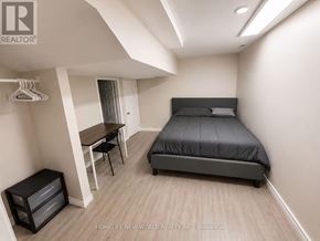 Mississauga (Erin Mills) apartment for rent - A bedroom with a bed, desk, and chair.