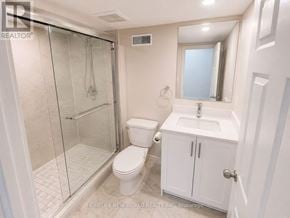 Mississauga (Erin Mills) apartment for rent - A white bathroom with a walk in shower and a toilet.