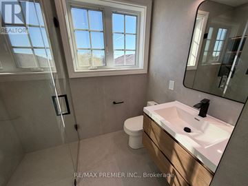 Toronto (Brookhaven-Amesbury) apartment for rent - A bathroom with a sink, mirror, and a window.