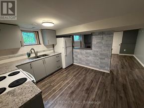 Toronto (Maple Leaf) apartment for rent - A kitchen with a stove top oven and a refrigerator.