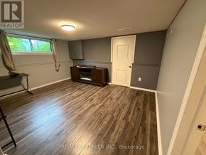 Toronto (Maple Leaf) apartment for rent - A room with a wooden floor and a window with curtains.