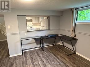 Toronto (Maple Leaf) apartment for rent - A room with a desk and a mirror on the wall.