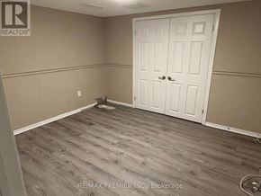 Toronto (Maple Leaf) apartment for rent - A room with a white door and wooden flooring.