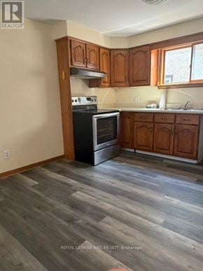 Welland (Lincoln/Crowland) apartment for rent - A kitchen with wood floors and cabinets.