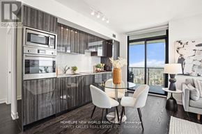 Toronto (Bay Street Corridor) condo for rent - A modern kitchen with a dining table and chairs.