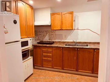 Mississauga (Cooksville) townhouse for rent - A kitchen with wooden cabinets and a white refrigerator.