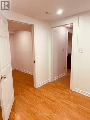Mississauga (Cooksville) townhouse for rent - A room with wooden floors and white walls.