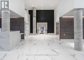 Vaughan (Concord) condo for rent - A white marble floor with a black wall and a doorway in the background.