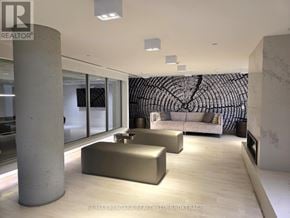 Vaughan (Concord) condo for rent - A modern living room with a large sofa and a patterned wall hanging.