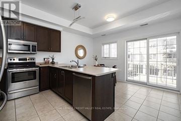 Burlington (Freeman) townhouse for rent - A kitchen with brown cabinets and a white countertop.