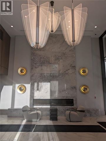 Hamilton condo for rent - A modern living room with a marble wall and a large chandelier.