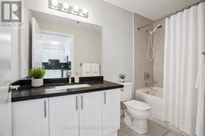 Oakville (Wm Westmount) condo for rent - A bathroom with a black countertop and white cabinets.