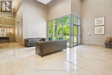 Oakville (Wm Westmount) condo for rent - A living room with a couch and a glass door leading outside.