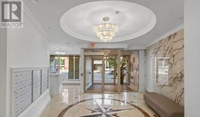 Toronto (Church-Yonge Corridor) condo for rent - A hallway with a chandelier, a bench, and a marble floor.