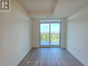 Toronto (Mount Pleasant West) condo for rent - A room with a view of the city through a large window.